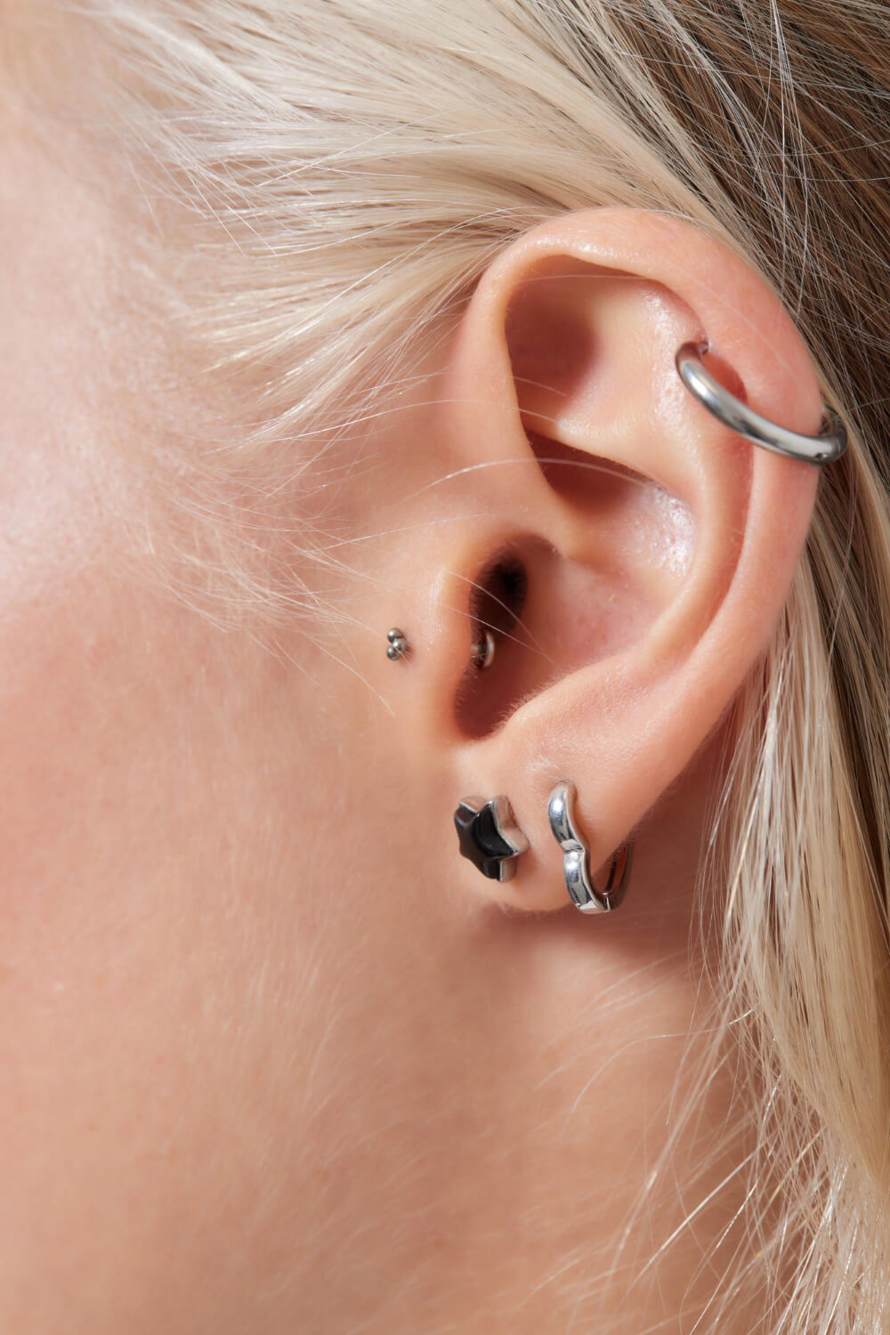 woman's ear with 4 earrings placed by a professional piercing expert